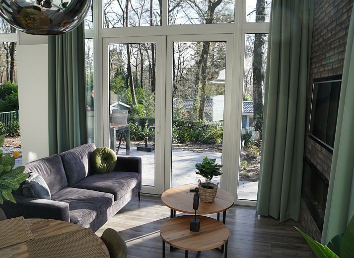 Gezellige woonkamer in Vakantiehuis Tiny House, Hoenderloo, Veluwe met veel natuurlijk lichtinval.