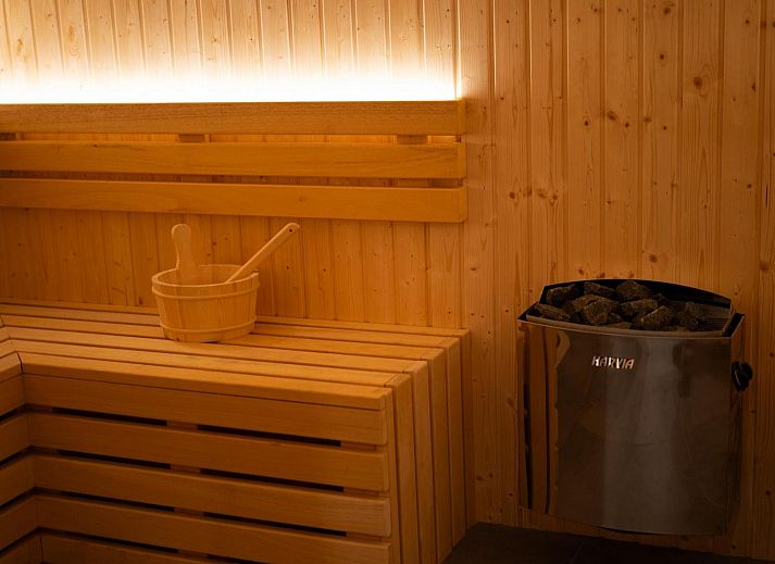 Terrace with parasol at Group Accommodation Specht, a vacation home in Hoenderloo, Veluwe surrounded by greenery.