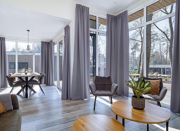 Family enjoys the pond at Holiday home Deerhoeve comfort in Hoenderloo, Veluwe. Perfect for relaxation and nature.