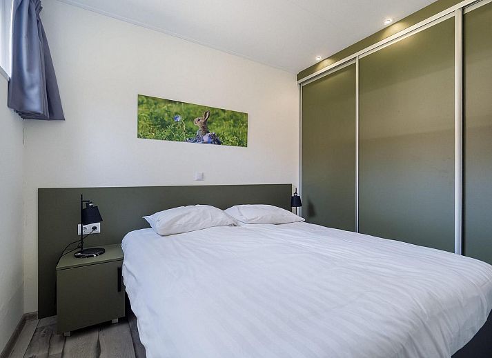 Spacious terrace at Vakantiewoning Hertenhoeve comfort in Hoenderloo, Veluwe. Ideal for outdoor dining and enjoying the surroundings.