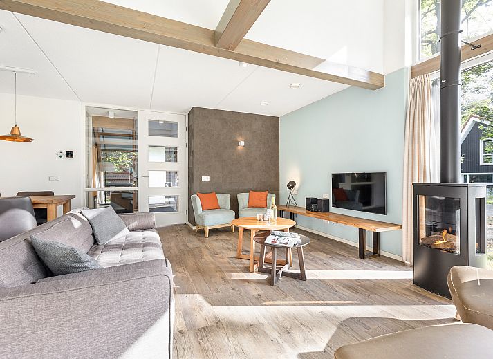 Dining room in Miggelenberg bungalow, Hoenderloo, Veluwe, Gelderland, with large wooden table.