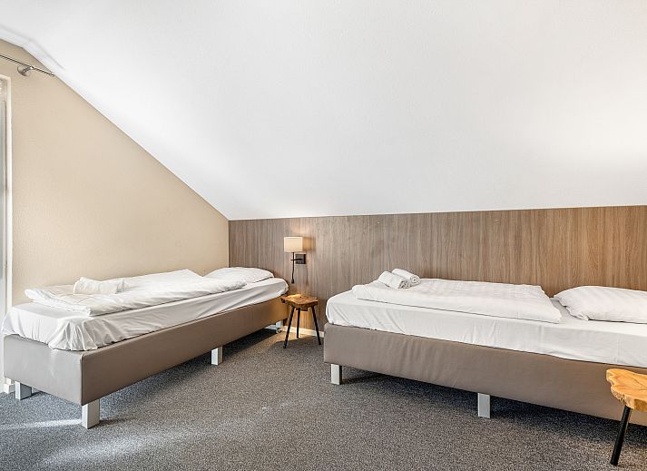 Modern living room with fireplace in Miggelenberg bungalow, Hoenderloo, Veluwe, Gelderland.