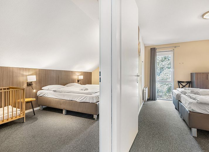 Modern living room with fireplace in Miggelenberg bungalow, Hoenderloo, Veluwe, Gelderland.
