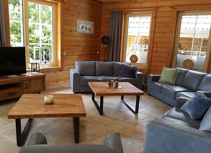 Groepsaccommodatie Bosuil in Hoenderloo, Veluwe, vakantiehuis met terras onder de bomen.