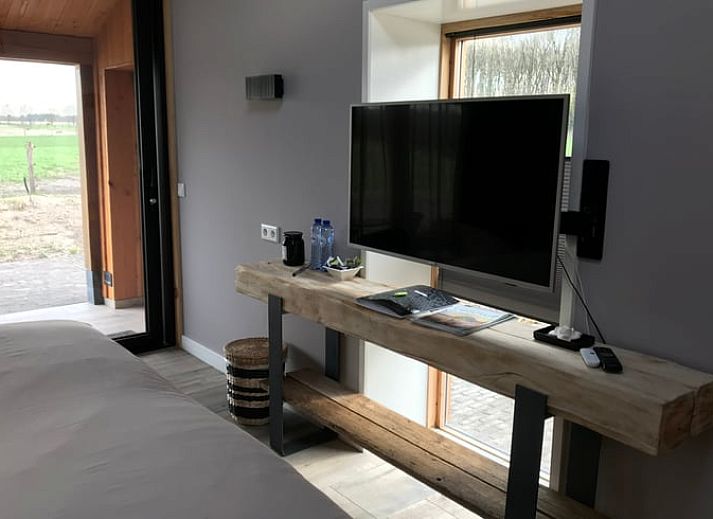 Prachtig uitzicht op de weilanden bij Vakantiehuisje in Garderen, Veluwe, met grazende paarden.