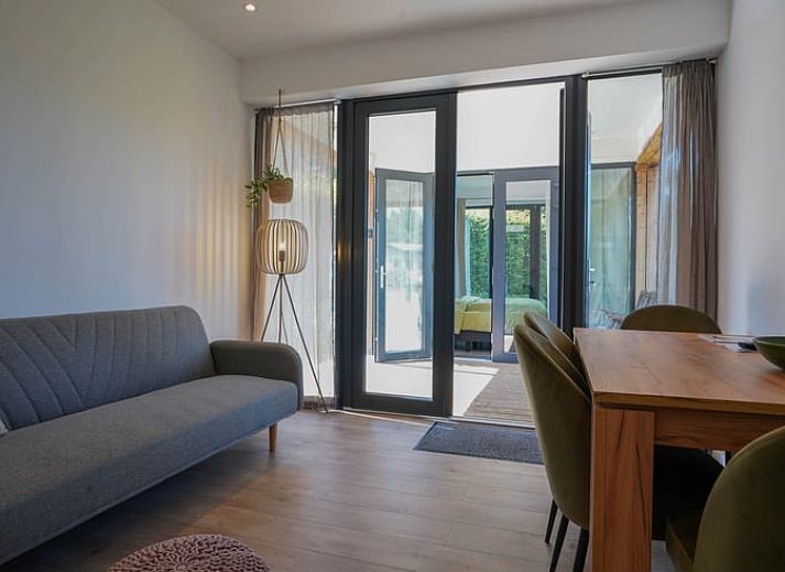 Spacious veranda of cottage in Elspeet overlooking green garden, Veluwe, Gelderland.