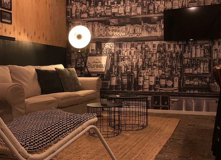 Cozy interior of Holiday Home in 't Harde, Veluwe, with wooden interior and sitting area.