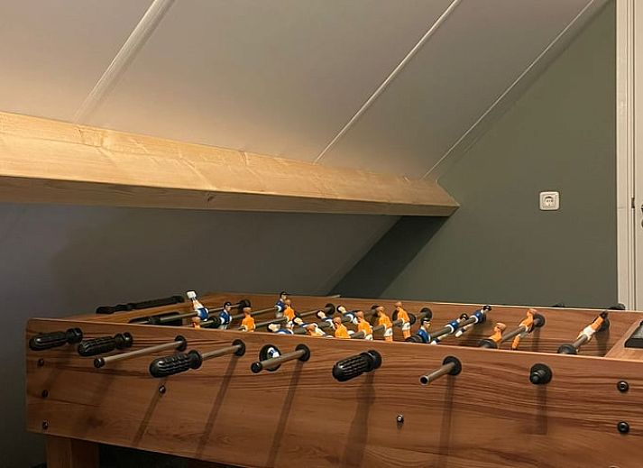 Cozy interior of Holiday Home in 't Harde, Veluwe, with wooden interior and sitting area.