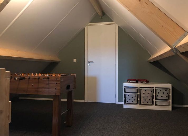 Cozy interior of Holiday Home in 't Harde, Veluwe, with wooden interior and sitting area.