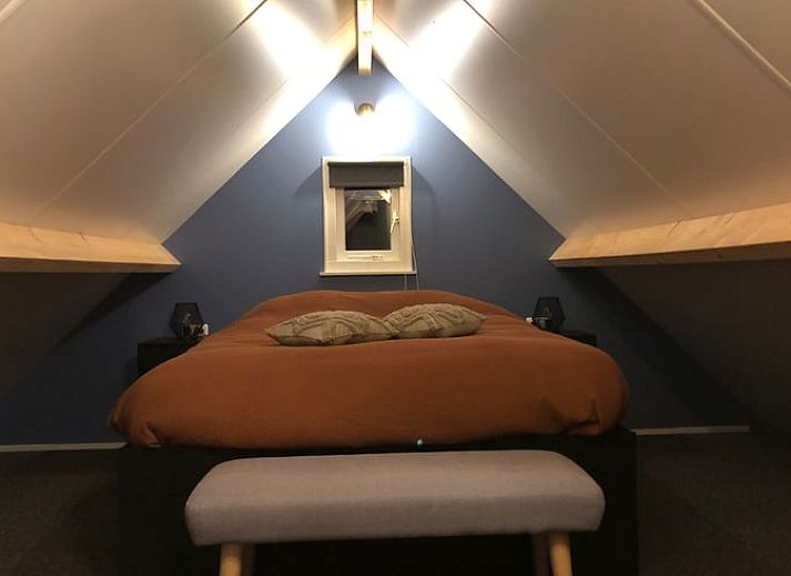 Cozy interior of Holiday Home in 't Harde, Veluwe, with wooden interior and sitting area.