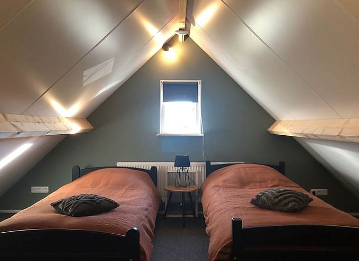 Dining room in Holiday Home in 't Harde, Veluwe, with modern furnishings and lots of natural light.