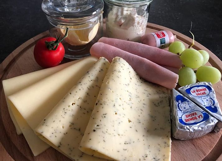 Dining room in Holiday Home in 't Harde, Veluwe, with modern furnishings and lots of natural light.