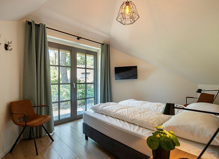 Overdekte zithoek op het terras van Vakantiewoning Sprielderbosch 14 't Sprielderhof in Putten, Veluwe.