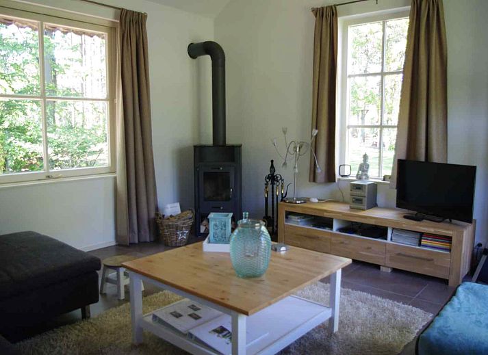 Exterior of vacation home DG1276 in Putten, Veluwe, surrounded by flowers and greenery.