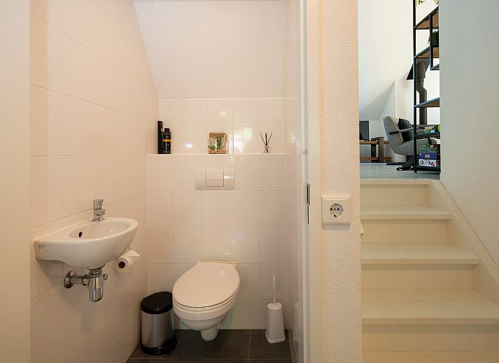 Rustic terrace at Vakantiewoning Sprielderbosch 5 De Bosuil in Putten, Veluwe with hanging chair.