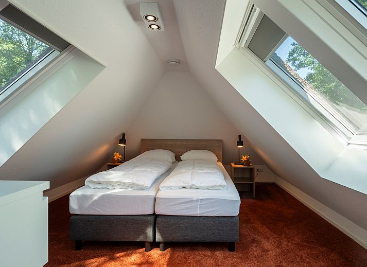 Relax in a hammock at Vakantiewoning Sprielderbosch 5 De Bosuil in Putten, Veluwe.