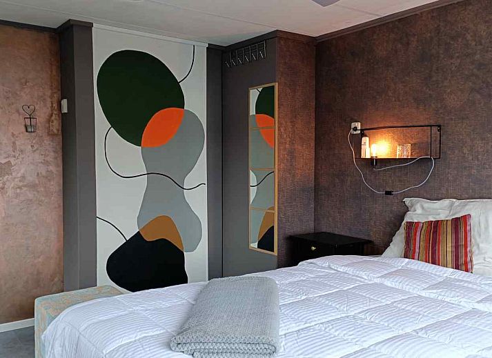 Attractive bedroom in DG1546 vacation home Putten Veluwe with natural light and comfortable furnishings.