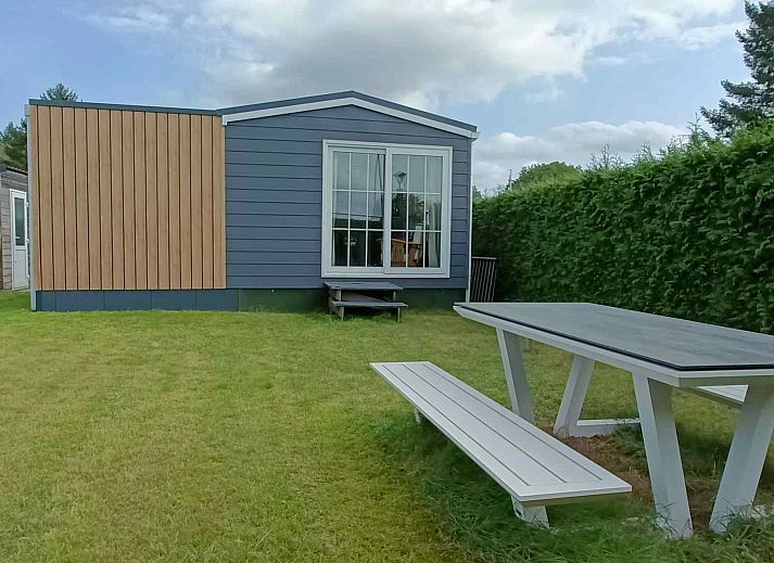 Cozy living room of DG1546 in Putten Veluwe with garden views and stylish decor.