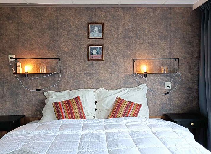 Cozy living room of DG1546 in Putten Veluwe with garden views and stylish decor.