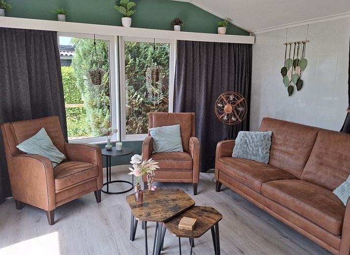 Decorative corner of Chalet Relax in Putten, Veluwe, Gelderland, with wooden ornaments and a welcome sign.