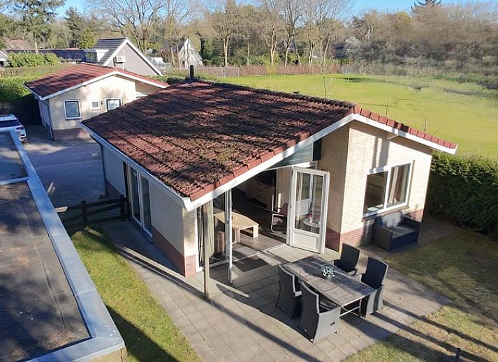 Bright living room of vacation home in Putten, Veluwe, Gelderland overlooking garden.