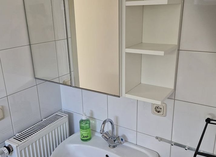 Comfortable sitting area in vacation home in Putten, Veluwe, Gelderland overlooking terrace.