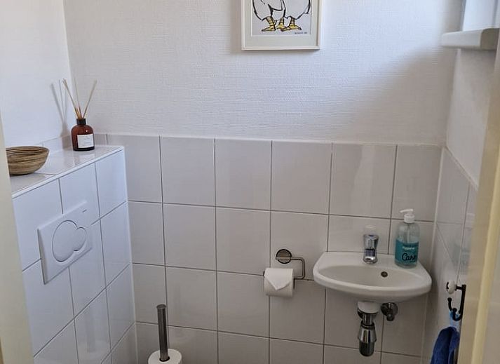 Comfortable sitting area in vacation home in Putten, Veluwe, Gelderland overlooking terrace.