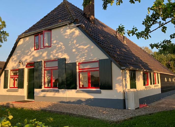 Dining area in Holiday Home in Wezep Oldebroek, Veluwe, Gelderland with spacious table and colorful chairs.