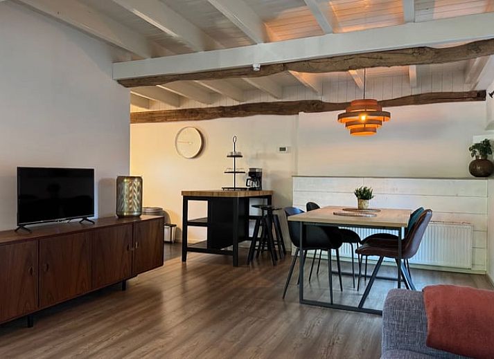 Esstisch mit Sonnenschirm im Garten des Ferienhauses in Vaassen, Veluwe, Gelderland.