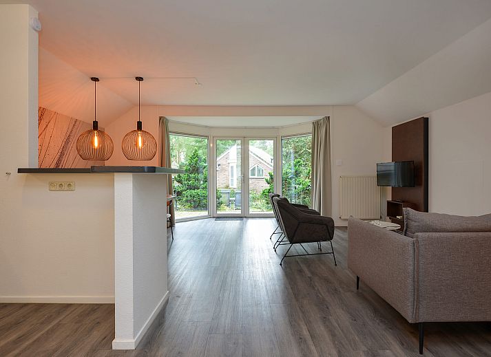 Rear of detached house in Vaassen, Veluwe, with green surroundings.