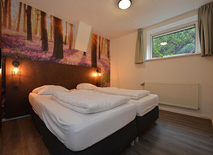 Terrace of vacation home in Vaassen, Gelderland, with garden furniture and green surroundings.