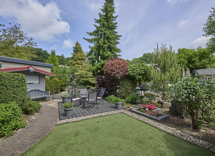Geniet van de serene tuin en het terras bij vakantiehuis Kerkuil in Hulshorst, Veluwe, Gelderland.