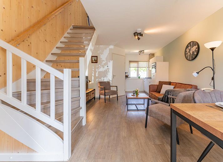 Cozy living room in vacation home Koolmees, Hulshorst, Veluwe with comfortable sofa and wooden interior.