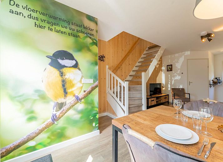 Cozy living room in vacation home Koolmees, Hulshorst, Veluwe with comfortable sofa and wooden interior.