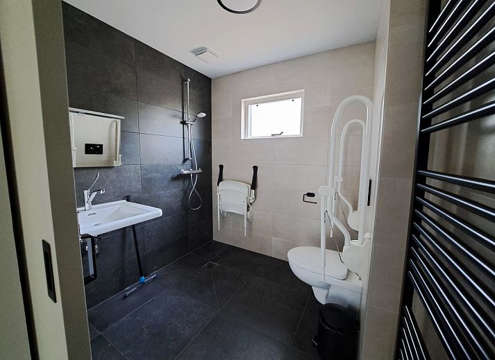 Essecke im adaptierten Bungalow het Edelhert, Ferienhaus in Epe, Veluwe, mit Holztisch und modernen Stuehlen.