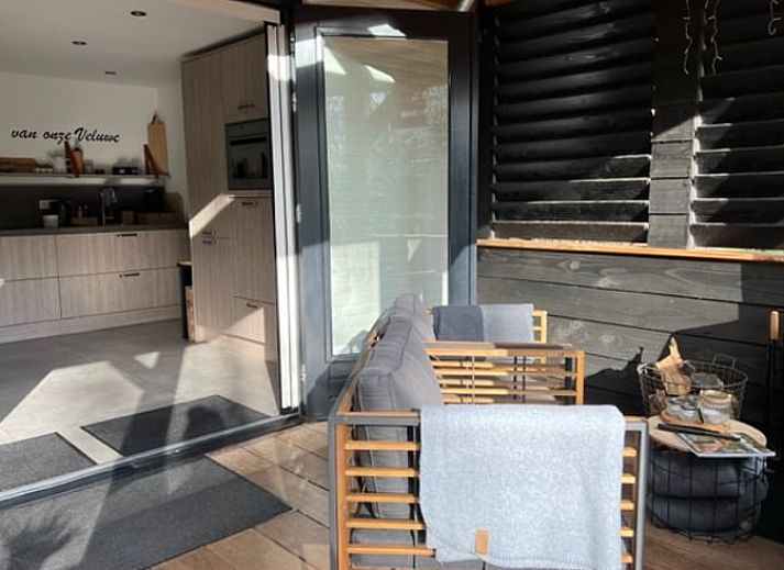 Enjoy the peace and quiet on the veranda of Holiday Home in Epe, Veluwe, Gelderland, overlooking the green garden and surrounding nature.