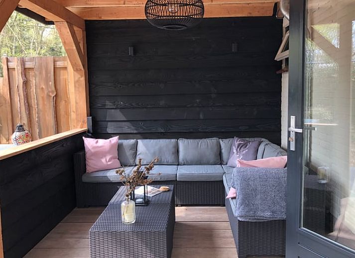 Enjoy the peace and quiet on the veranda of Holiday Home in Epe, Veluwe, Gelderland, overlooking the green garden and surrounding nature.