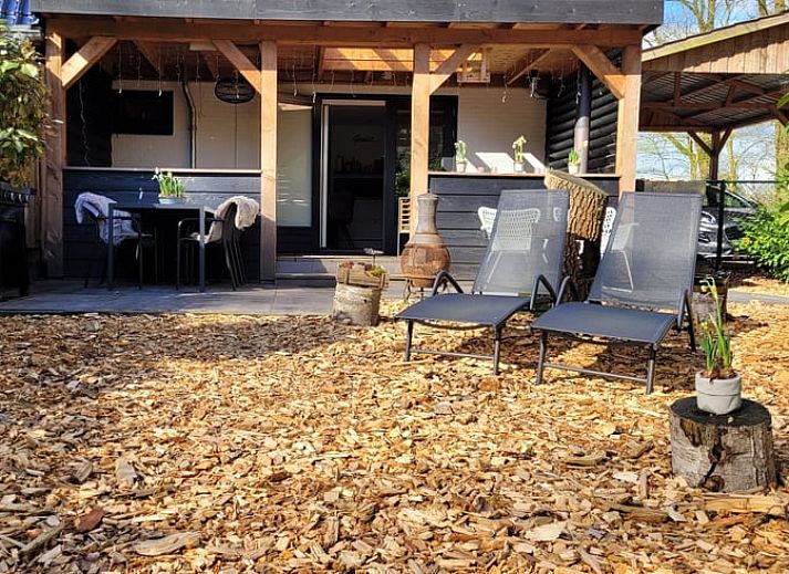 Enjoy the cozy veranda of Holiday Home in Epe in Veluwe, Gelderland, with comfortable seating areas and green surroundings.