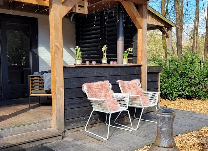 Enjoy the cozy veranda of Holiday Home in Epe in Veluwe, Gelderland, with comfortable seating areas and green surroundings.