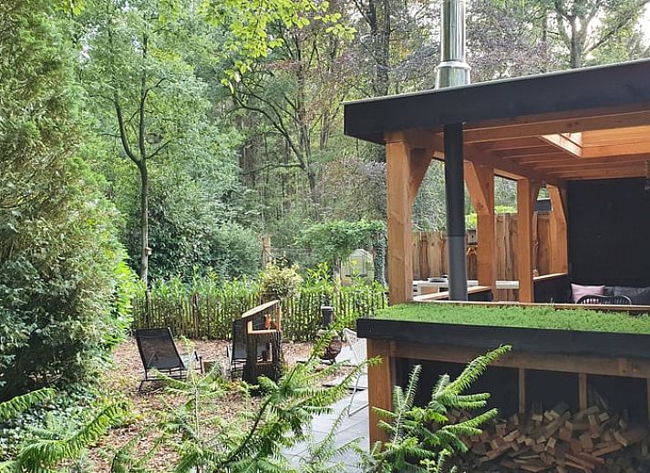 Enjoy the cozy veranda of Holiday Home in Epe in Veluwe, Gelderland, with comfortable seating areas and green surroundings.