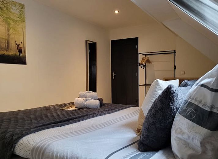 Cozy interior of Cottage in Epe, Veluwe with warm wood stove and drinks board, perfect for relaxation in Gelderland.