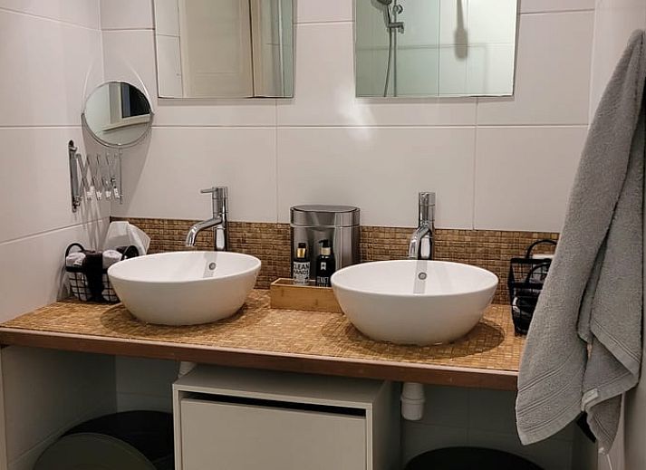 Cozy interior of Cottage in Epe, Veluwe with warm wood stove and drinks board, perfect for relaxation in Gelderland.