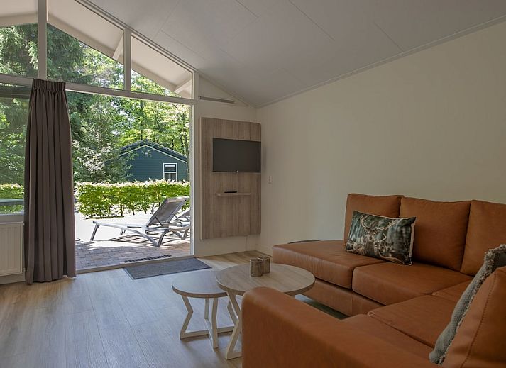 Enjoy nature on the terrace of S4A Comfort bungalow in Epe, Veluwe, Gelderland, surrounded by green forests.