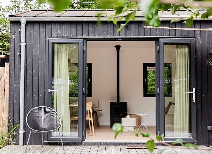 Enjoy the terrace at Cottage in Nunspeet, Veluwe, Gelderland, with an inviting dining table and green surroundings.