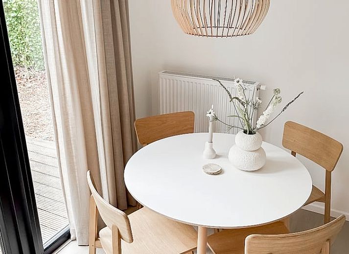 Enjoy the terrace at Cottage in Nunspeet, Veluwe, Gelderland, with an inviting dining table and green surroundings.