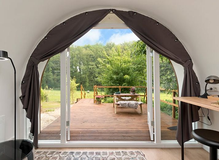Vakantiehuisje in Rheden, Veluwe, Gelderland met charmante houten veranda omringd door groen.