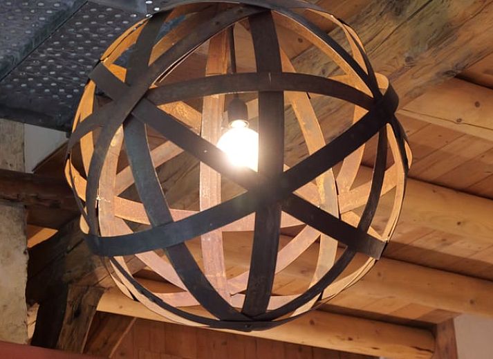 Cozy terrace at Cottage in Heerde, vacation home in the Veluwe, surrounded by flowers and greenery.