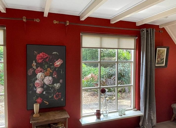 Geraeumige Terrasse am Ferienhaus in Wapenveld, Veluwe, Gelderland, umgeben von gruener Natur.