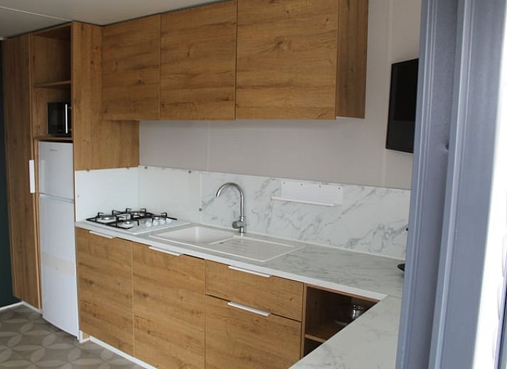 Veranda des Ferienhauses in Lieren, Veluwe, Gelderland mit Blick auf den gruenen Garten.