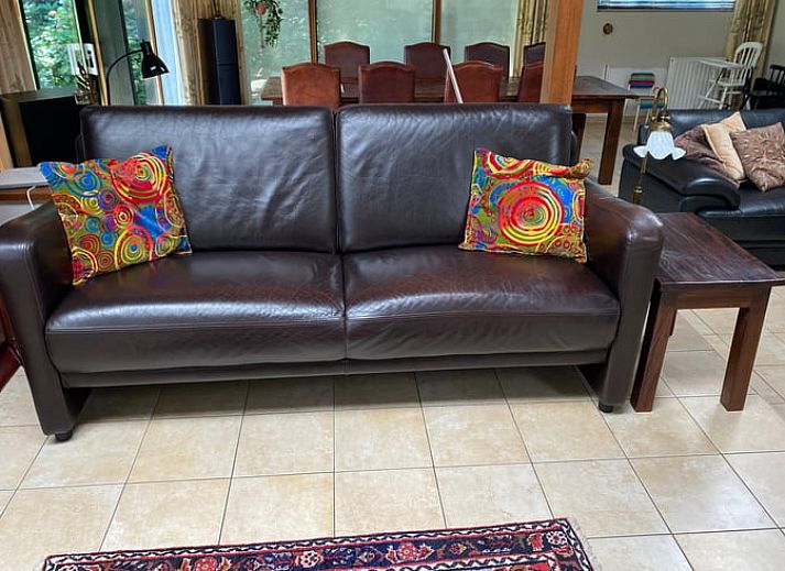 Ingang van vakantiehuisje in Bennekom met bloeiende rododendrons, perfect voor een Veluwe vakantie.